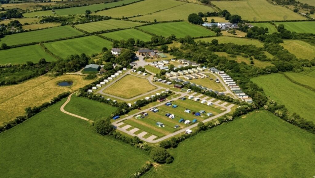 zoomed out view of a campsite featuring tents and caravans
